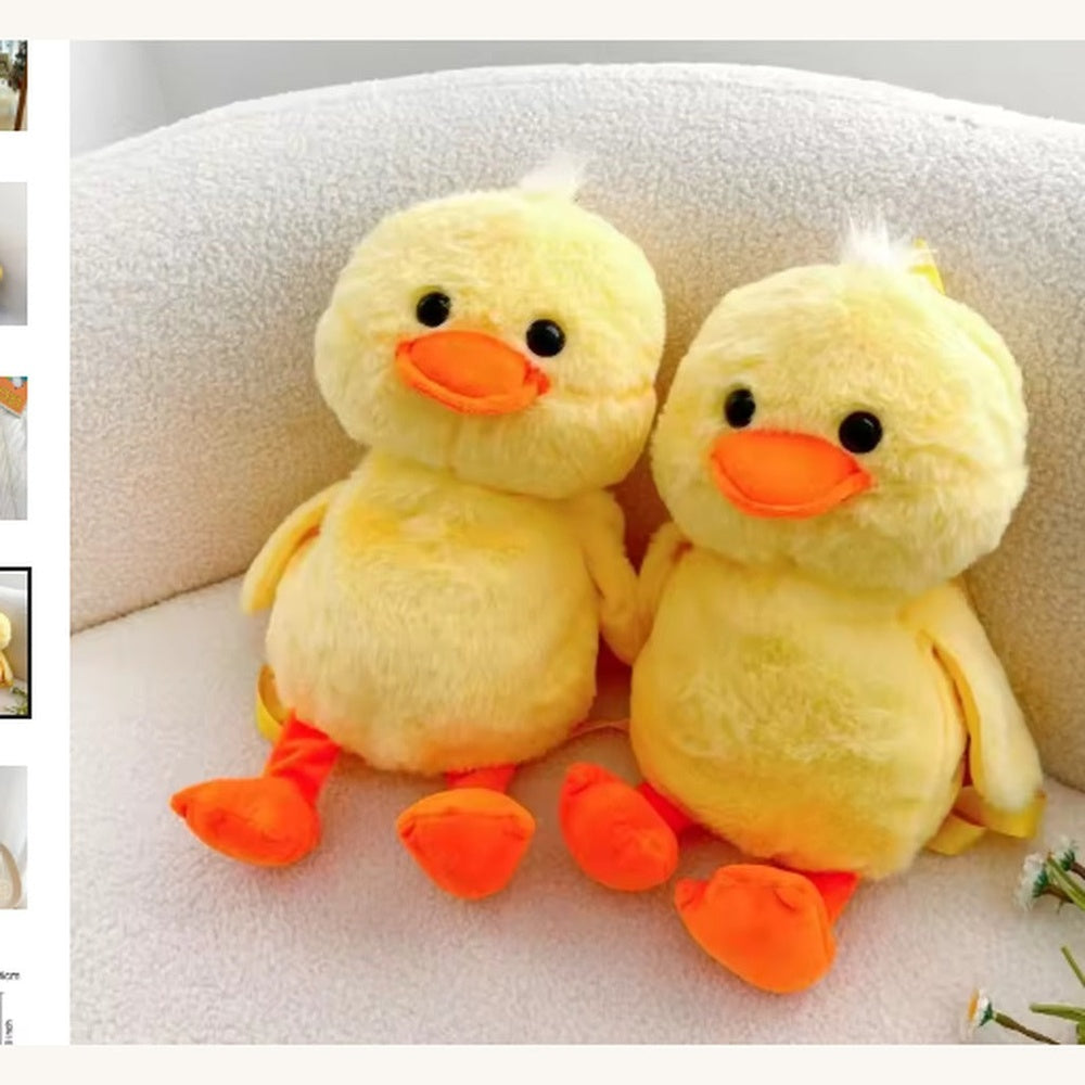 Two fluffy baby ducklings on white cozy chair